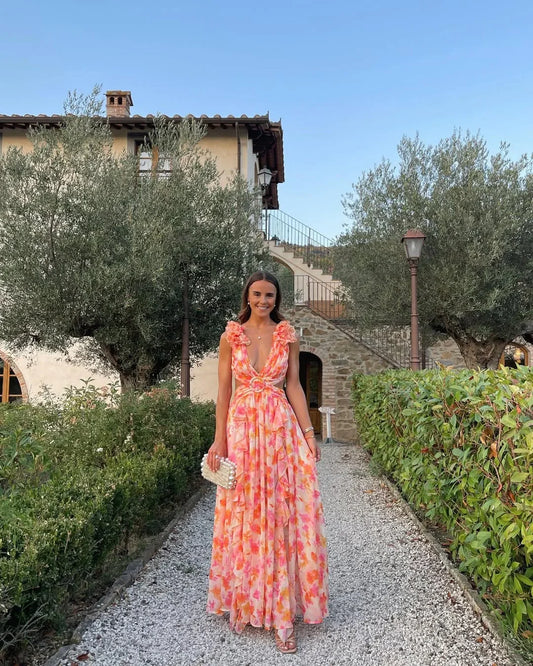 Robe maxi sans manches à fleurs, en coton léger, avec un décolleté en V et une ceinture à nouer à la taille.